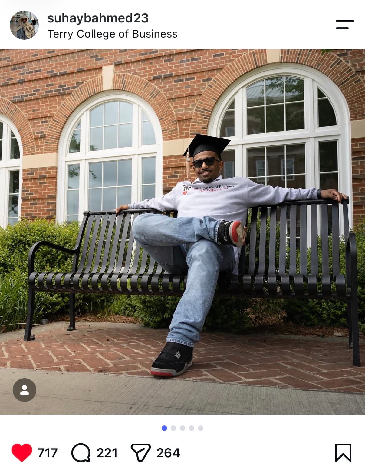 Instagram post: Terry College of Business grad in cap and sunglasses, kicked back on a bench outside the business school — 717 likes
